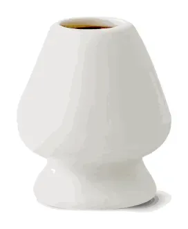 A white ceramic whisk stand, flared like a bell